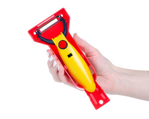 Vegetable peeler tool in hand on white background isolation