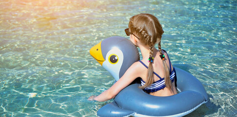  Summertime. Little girl swims in sea. Summer concept. Little girl on summer vacation.