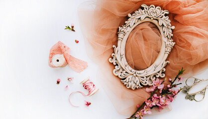 Vintage spring background with shabby photo frame, cherry blossom branch, fabric, french lace and satin ribbon. Pastel colors. Top view with copy space.