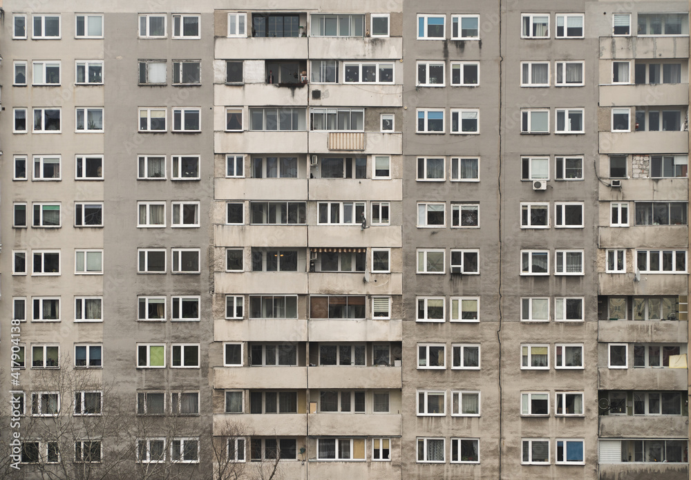 Sticker window pattern of a facade of an old building with many flats and flats in the middle class suburbs 