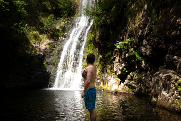 Fototapeta na wymiar Man in the waterfall in Asturias