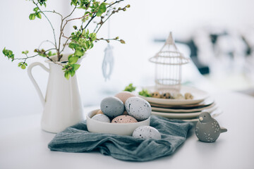 Easter background with eggs and spring branches. Happy Easter. Table setting. Holidays background.