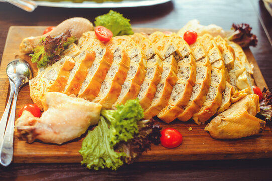 Beautiful Chicken And Mushroom Pie With Herbs, Tomatoes And Chicken Legs On A Wooden Board In A Restaurant. Selective Focus, Close-up