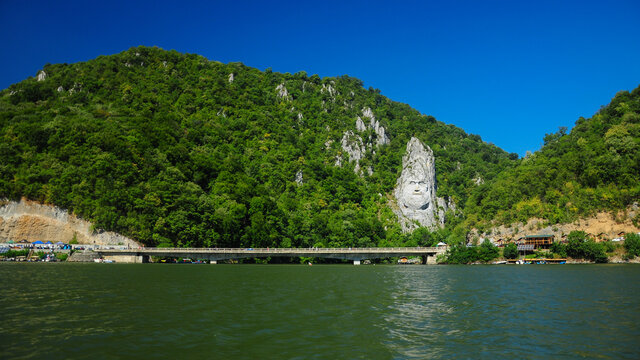 The huge stone carved statue showing the portrait of the ancient dacian king: Decebal. The sculpture is located on the shore of Danube River, Eselnita, Romania 