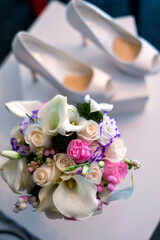 Bouquet of flowers and wedding shoes.