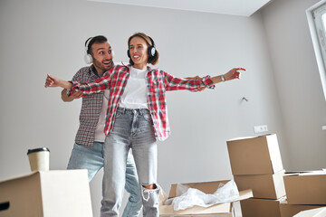 Young couple having fun in their new apartment