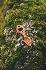 Traditional wooden love spoon from Wales on moss background. 