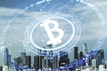 Double exposure of creative Bitcoin symbol hologram on Los Angeles city skyscrapers background. Cryptocurrency concept