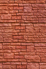 Background texture red, stone brick wall. Surface with a brickwork of bricks of different sizes