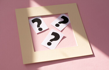 a question mark on a white sheet in the frame . FAQ frequency asked questions, Answer, Information and Brainstorming Concepts