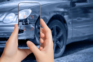 A girl takes pictures on a smartphone of car damage at the scene of an accident for insurance...