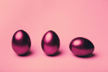 Pink easter eggs on a color background.