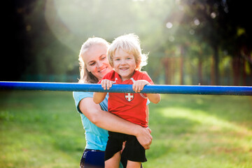 mom with a child in the park on a sports equipment, fitness, healthy lifestyle.