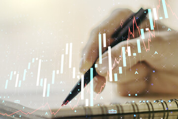 Multi exposure of abstract creative financial graph with hand writing in notepad on background, forex and investment concept