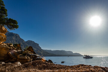 A small boat yacht on the clear tourquoise transparent sea ocean water of mediterranean balearic coast of Mallorca majorca