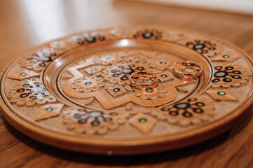 Wedding rings on a golden plate