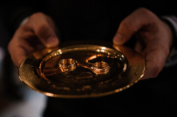 Wedding rings on a golden plate