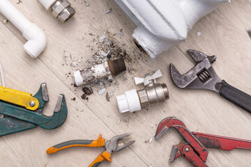 Plumber's different tools and equipment for repair valve of central heating broken radiator and...