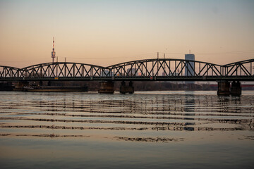 Railway bridge over the Danube River in Vienna, Austria during sunset
