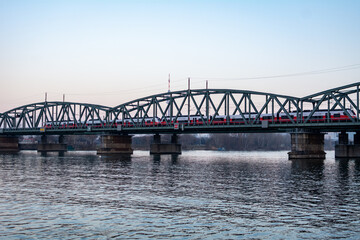 Obraz premium Railway bridge over the Danube River in Vienna, Austria during sunset