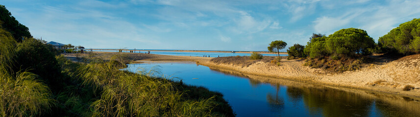 Panoramic of El Portil beach with sky clouds