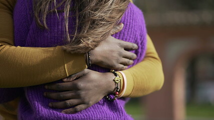 Interracial couple empathic embrace. Young woman romantic connection with partner outside