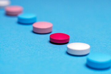 Obraz na płótnie Canvas Medication selection concept. The same red pill.