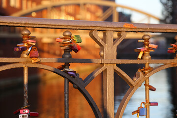 Fototapeta na wymiar Love locks on bridge in Hamburg Hafencity, lit by the setting sun
