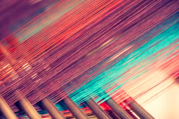 Foto op Canvas Multicolored straight strands texture background, sewing equipment, loom equipment at a garment factory © Aleksandr Matveev