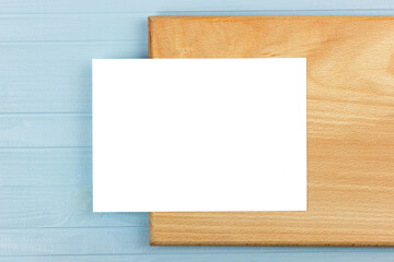 mockup of invitation card. Workspace concept, sheet of paper on wooden board