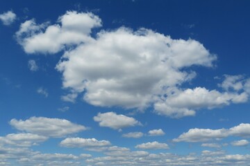 Naklejka na ściany i meble Blue sky with beautiful fluffy cumulus clouds, natural background 