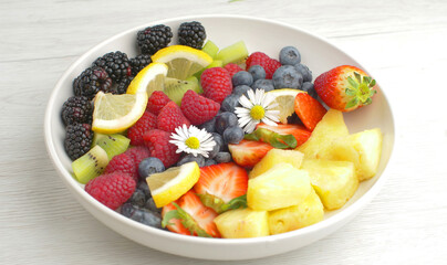 delicious fruit salad with fresh strawberry,kiwi,blackberry,pineapple and raspberry
