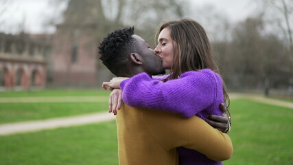 Interracial couple together. Young woman hugging caring for partner, affection and love