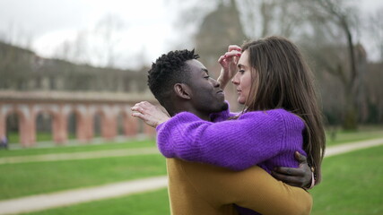 Interracial couple together. Young woman hugging caring for partner, affection and love