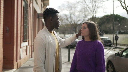 Interracial couple together. African man caressing girlfriend