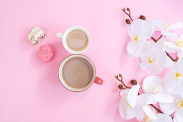 Fototapeta na wymiar Women day 8 March concept. Morning coffee, macarons and white orchid flowers on pink pastel background. Flat lay. orkide