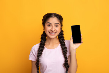Indian woman showing blank cellphone screen for mockup