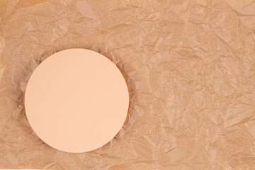 Minimal pastel color round pedestal platform. Blank empty podium display on crumpled craft paper background. Top view