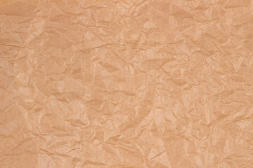 Old crumpled brown craft paper texture background. Top view
