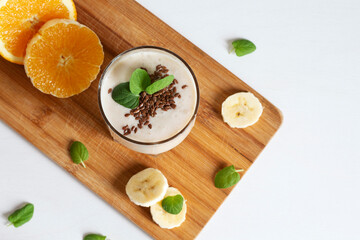 Delicious fresh banana orange smoothie with flaxseeds and mint. Healthy eating.