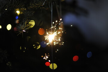 Fototapeta na wymiar sparkler in the Christmas tree