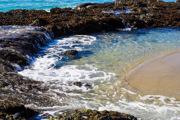 a stunning shot of vast blue ocean water with waves rolling in crashing against the rocks at West Street Beach in Laguna Beach California © Marcus Jones