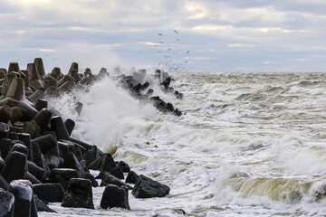 storm on the Baltic coast, waves hitting the breakwater concrete tetrapods