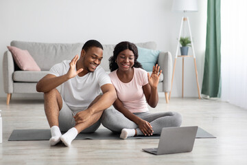 Happy black couple saying bye to yoga coach after lesson