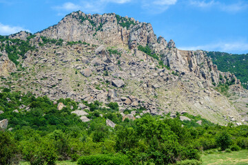 Fototapeta na wymiar Panorama of mountains in Valley of Ghosts, near Alushta, Crimea. In central part of photo possible to see multi-ton boulders that collapsed as a result of weathering & earthquakes
