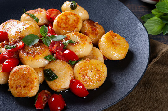 Artisan gnocchi stuffed with cheese, with cherry tomatoes, garlic, olive oil and basil