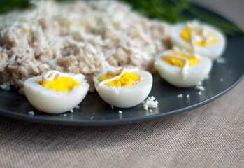 Breakfast on a plate oatmeal, egg and greens close-up.