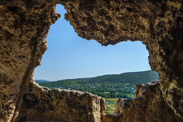 View from 'window' of ancient monk cave cell onto surrounding landscape. It's located in Inkerman Cave Monastery, Crimea. Monks founded monastery about VIII AD as this rocks hid them safely