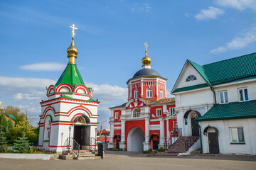 Fototapeta na wymiar Buildings of Kizichesky monastery, Kazan, Russia. Colorful chapel is on foreground, red church of St Vladimir is bit further. Most of buildings were founded in XVII century