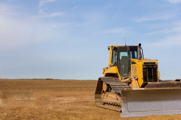Bulldozer on the construction of a new road. Construction machinery. Dedicated Construction machinery for handling bulk materials